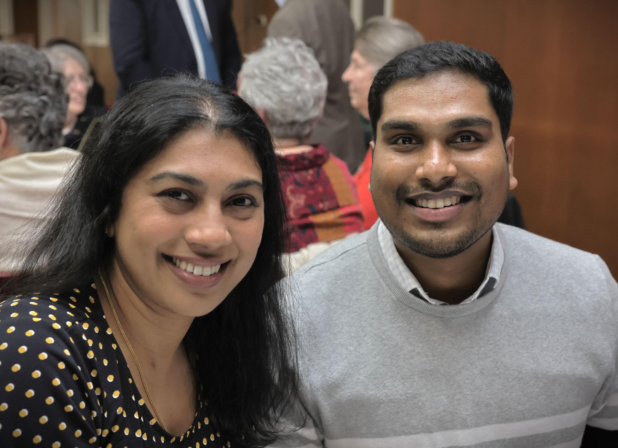 Two guests smiling at the gathering