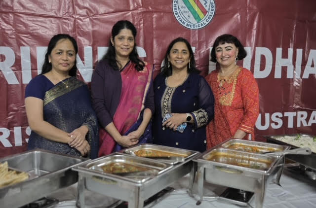 Volunteers beside the buffet at the gathering