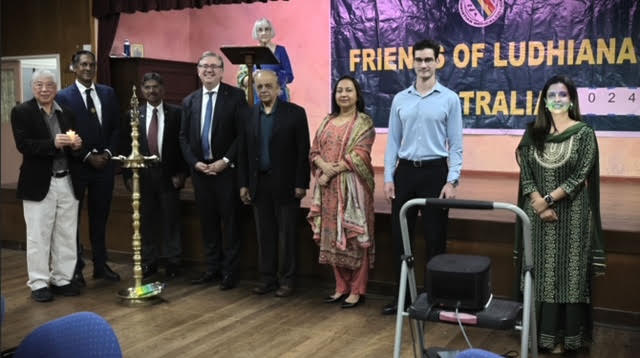 Group photograph of alumni and supporters on stage
